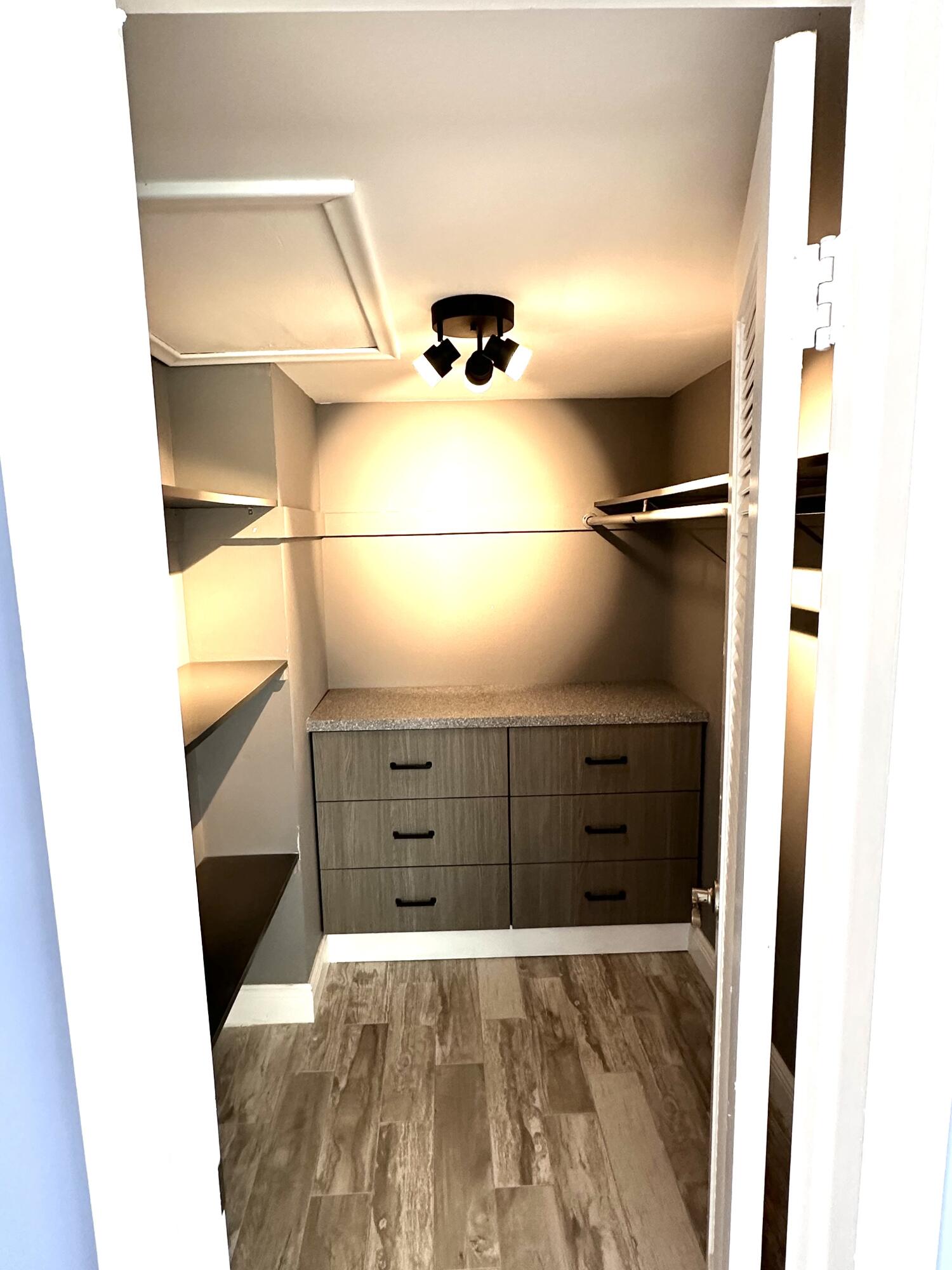 2162 Northeast 36th Street, Unit 46 Lighthouse Point, FL 33064 - Photo 9 of 15 a bedroom with a bed and a cabinets