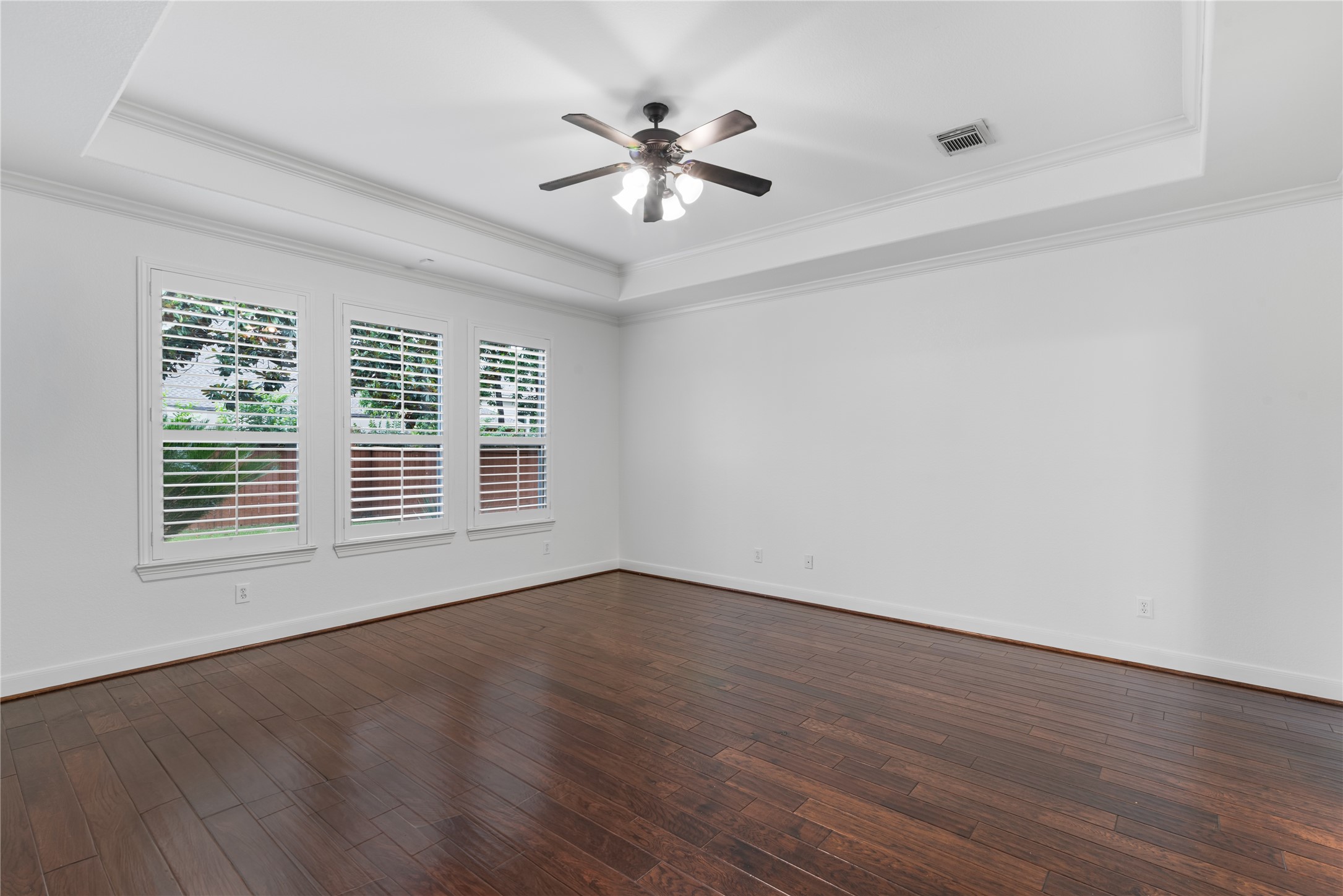 155 South Arrow Canyon Circle Spring, TX 77389 - Photo 19 of 49 a view of an empty room with wooden floor and a ceiling fan