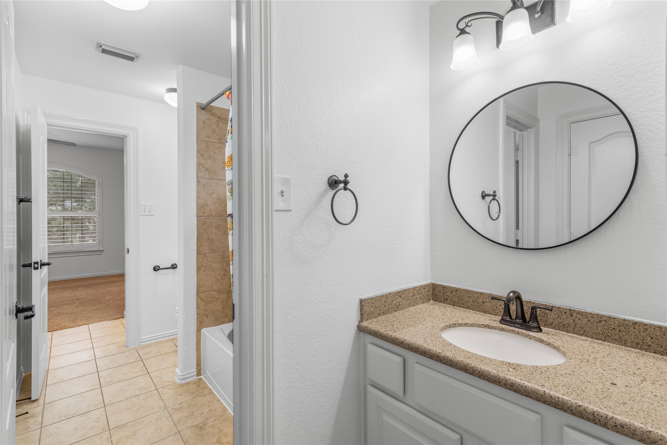 155 South Arrow Canyon Circle Spring, TX 77389 - Photo 31 of 49 a bathroom with a granite countertop sink a mirror and a shower
