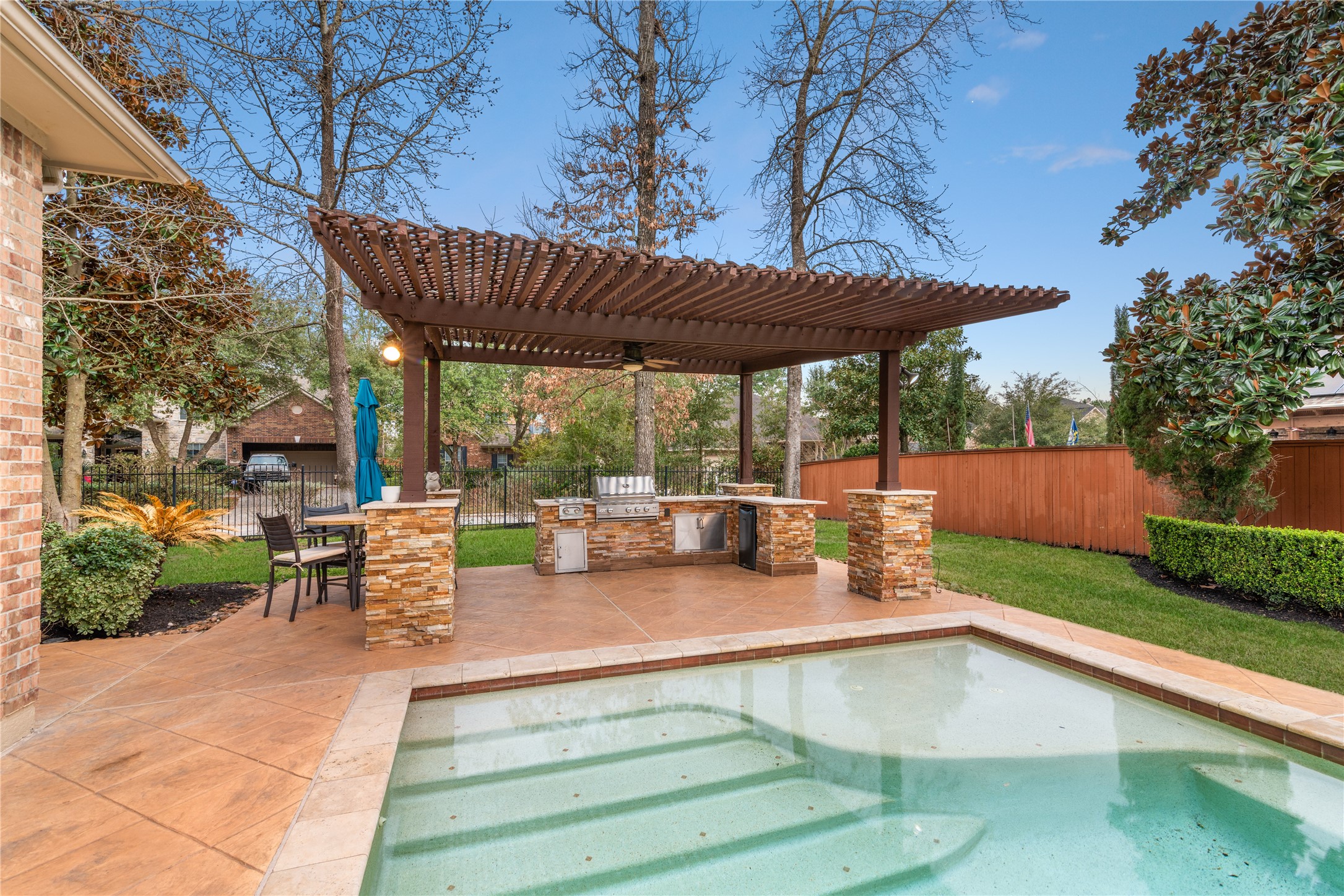155 South Arrow Canyon Circle Spring, TX 77389 - Photo 36 of 49 a view of a patio with table and chairs potted plants and a large tree
