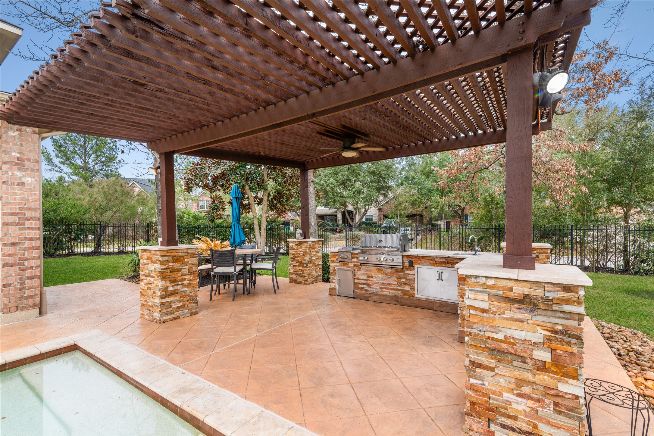 155 South Arrow Canyon Circle Spring, TX 77389 - Photo 37 of 49 a view of a patio with table and chairs potted plants with large tree