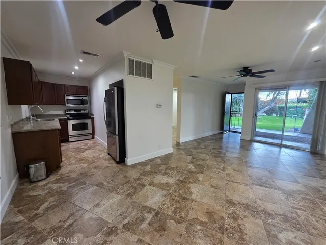 wooden floor in kitchen and a refrigerator in a room