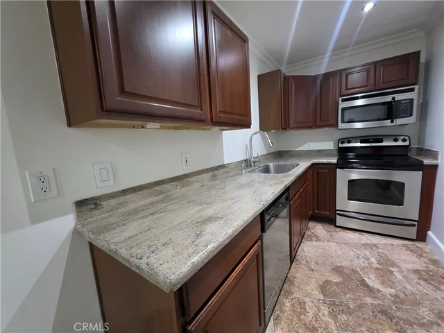 a kitchen with sink cabinets and stainless steel appliances