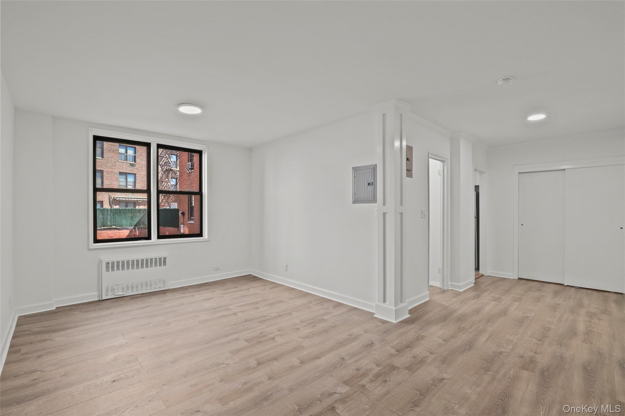 555 Bronx River Road, Unit 1J Yonkers, NY 10704 - Photo 1 of 11 wooden floor in an empty room with a window