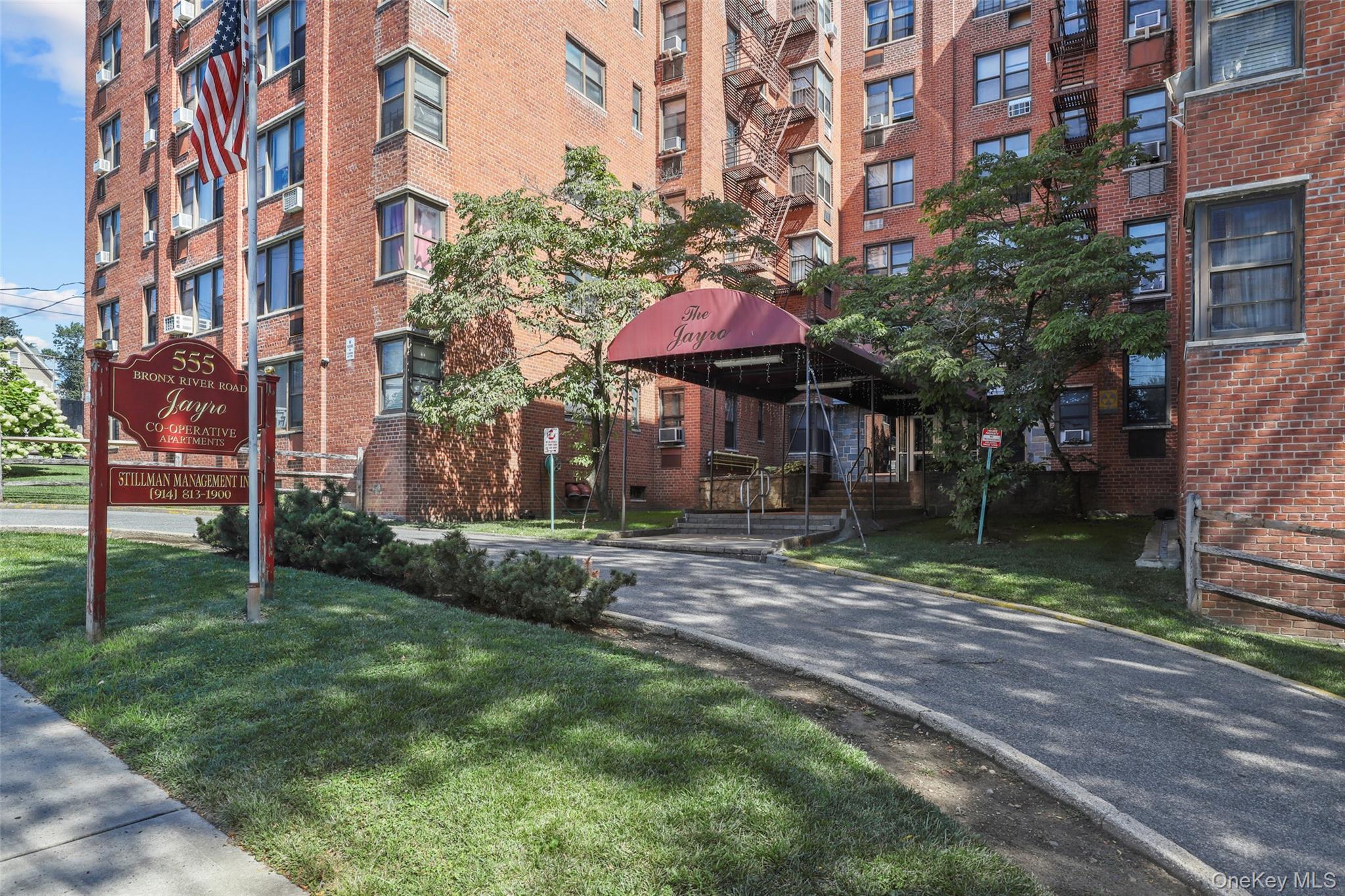 555 Bronx River Road, Unit 1J Yonkers, NY 10704 - Photo 9 of 11 a view of a house with a yard