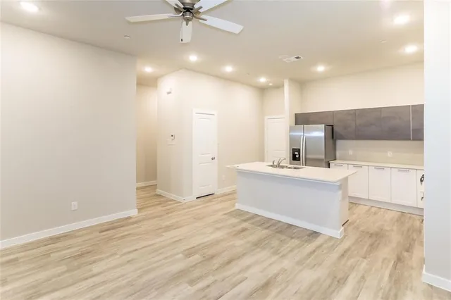 a view of a kitchen with a sink and a living room