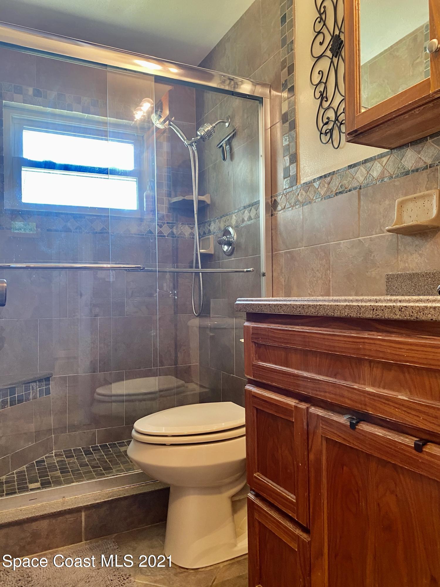 993 Cardon Drive Rockledge, FL 32955 - Photo 15 of 22 a bathroom with a toilet and a shower