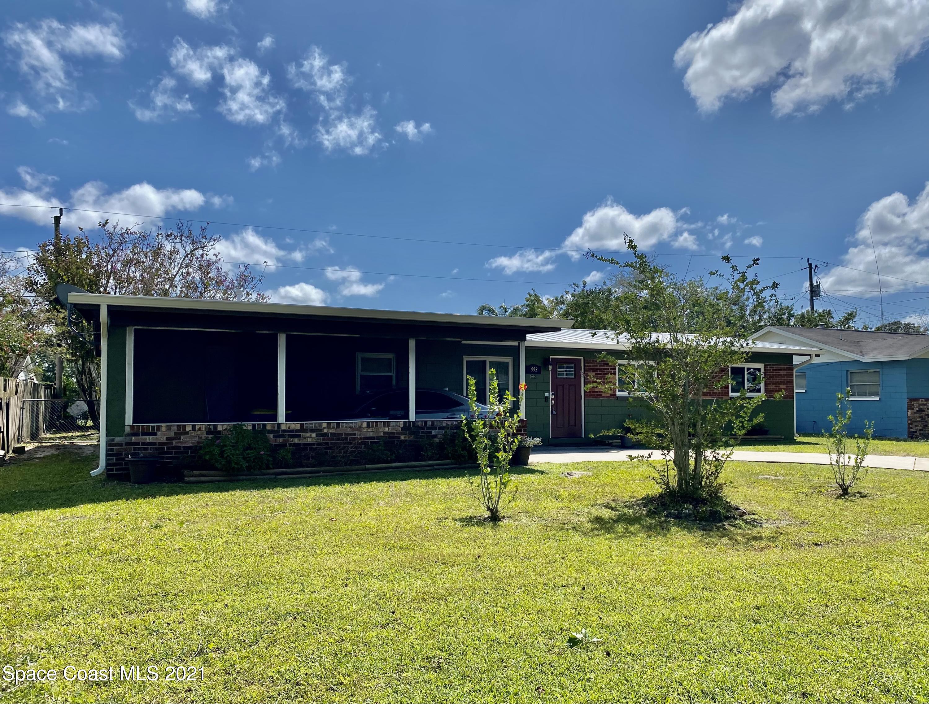 993 Cardon Drive Rockledge, FL 32955 - Photo 2 of 22 a view of a house with swimming pool and a yard