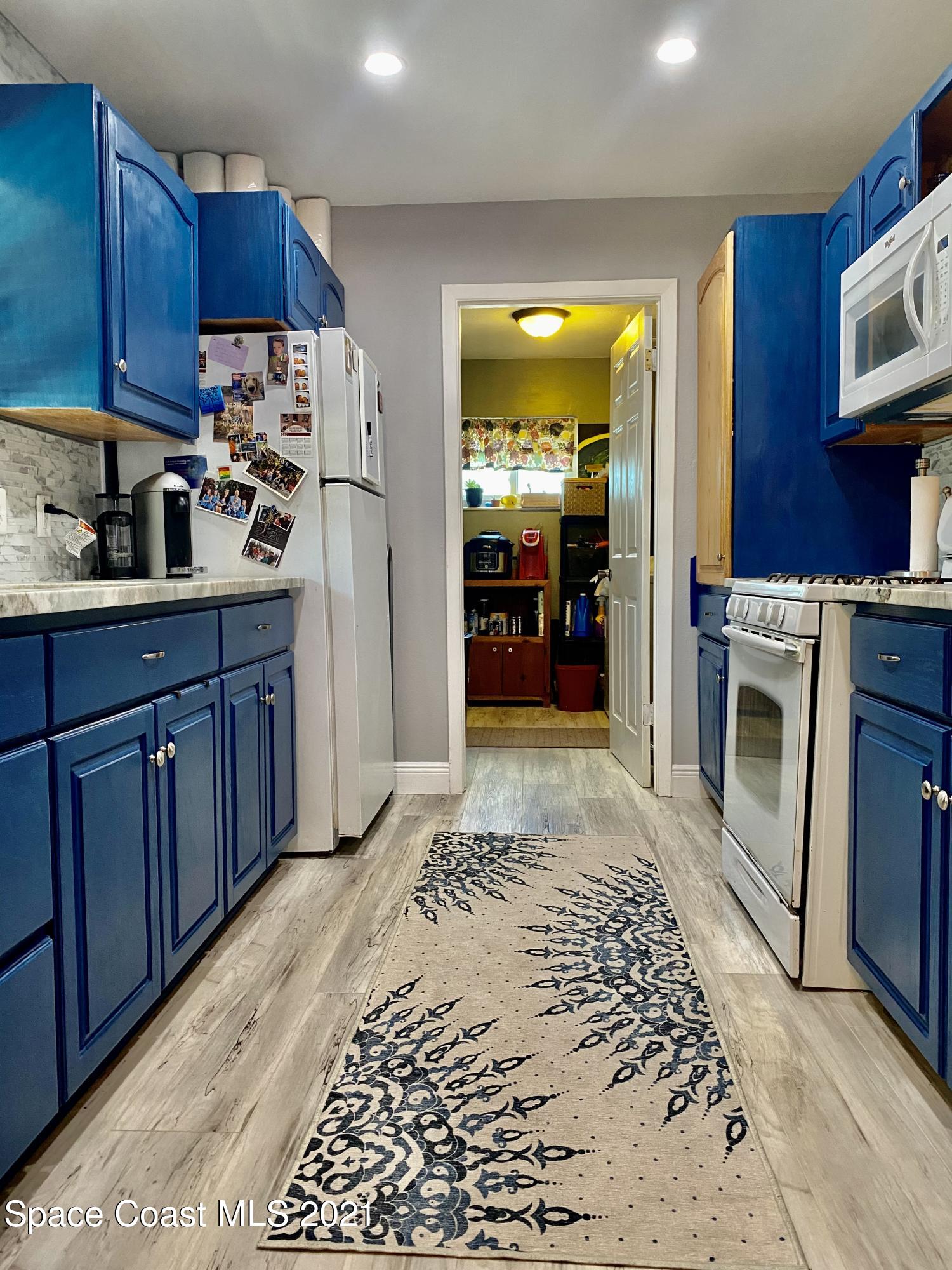993 Cardon Drive Rockledge, FL 32955 - Photo 3 of 22 a kitchen with stainless steel appliances granite countertop a refrigerator sink and cabinets