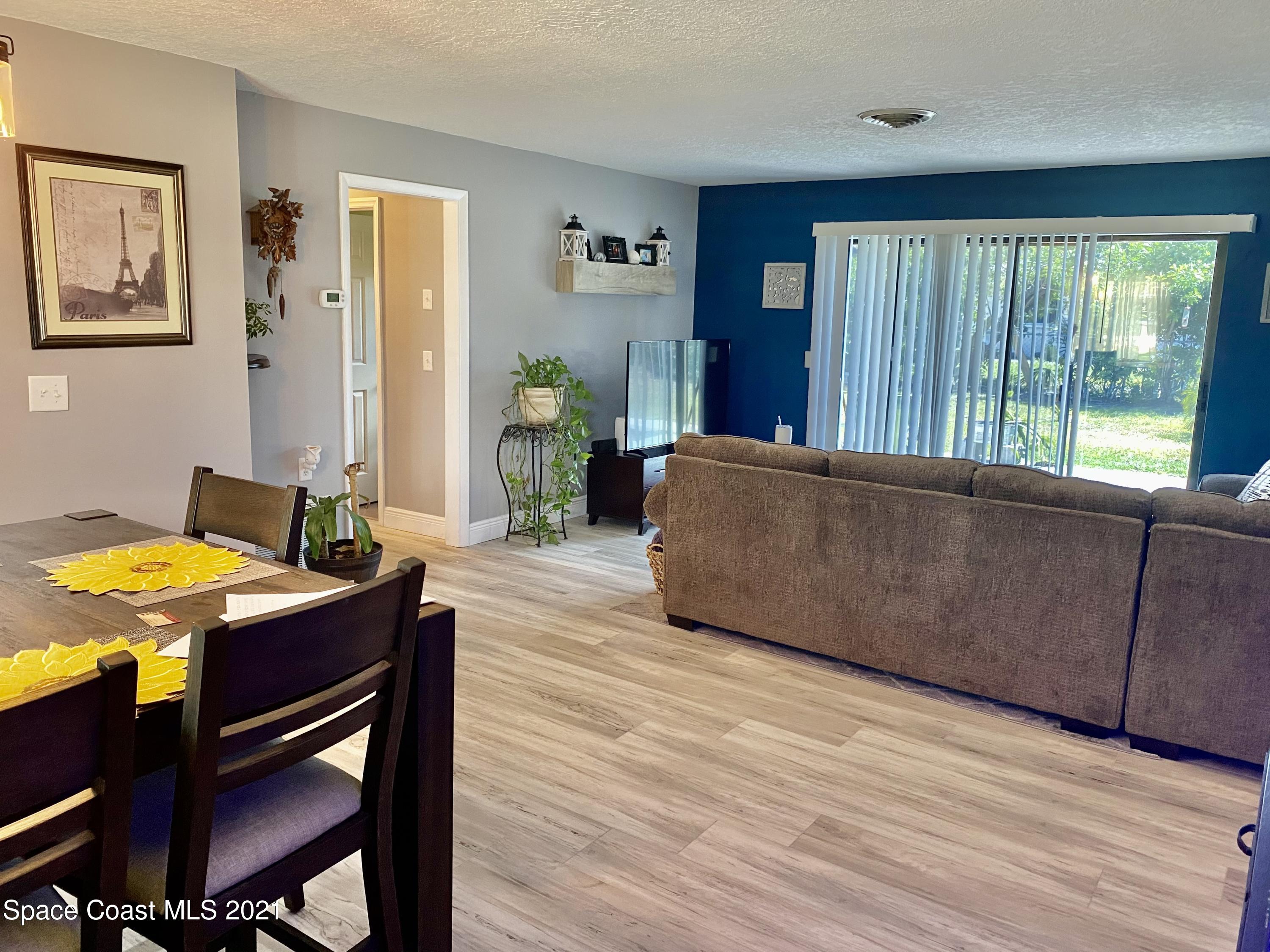 993 Cardon Drive Rockledge, FL 32955 - Photo 7 of 22 a living room with furniture and a table