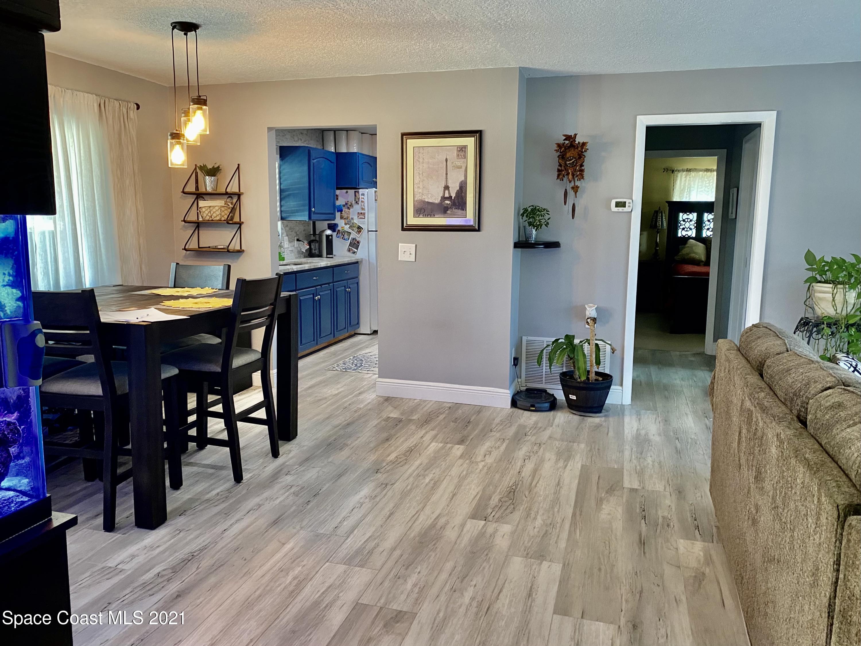 993 Cardon Drive Rockledge, FL 32955 - Photo 8 of 22 a living room with furniture and wooden floor