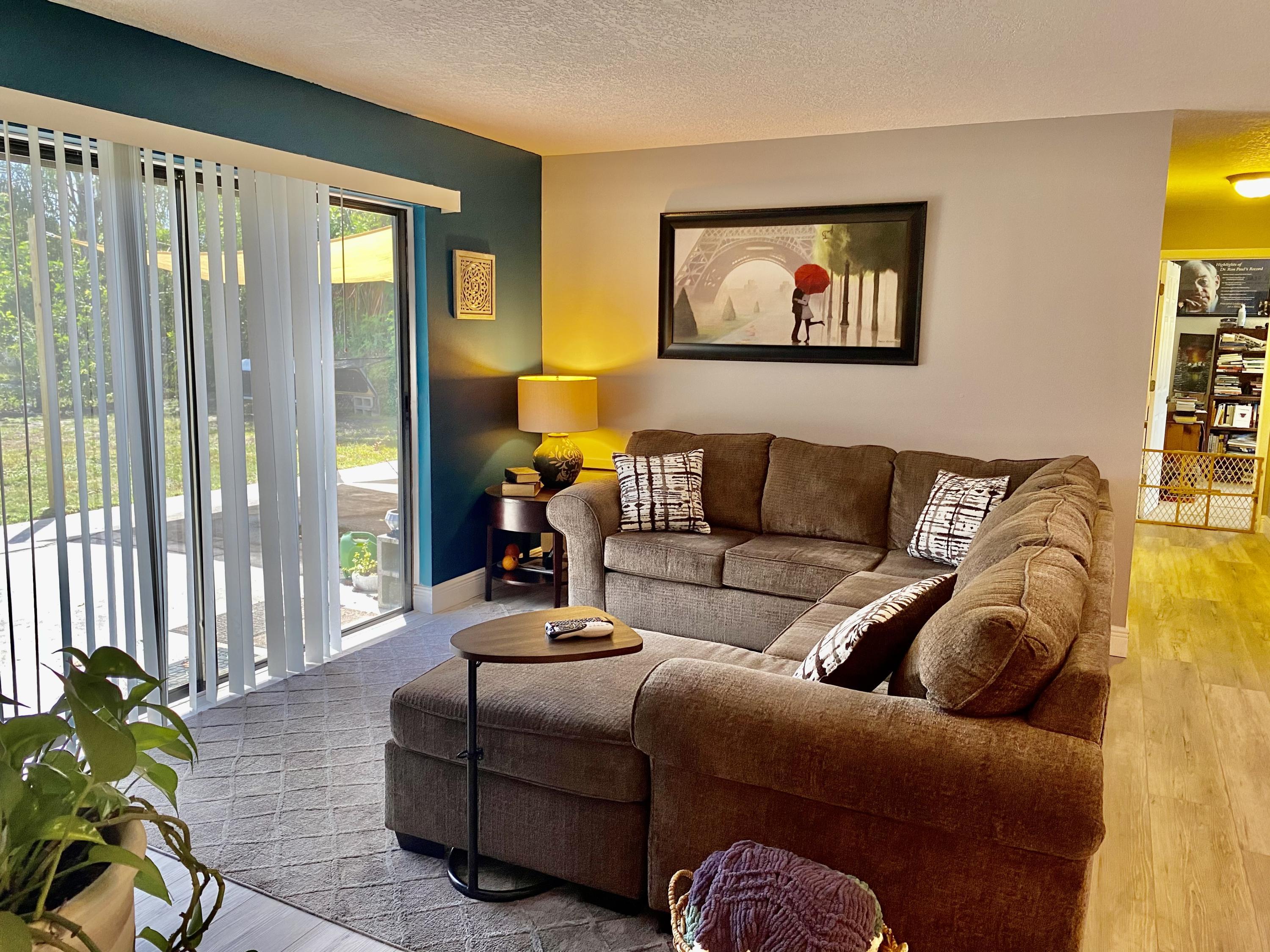 993 Cardon Drive Rockledge, FL 32955 - Photo 10 of 22 a living room with furniture fireplace and a large window