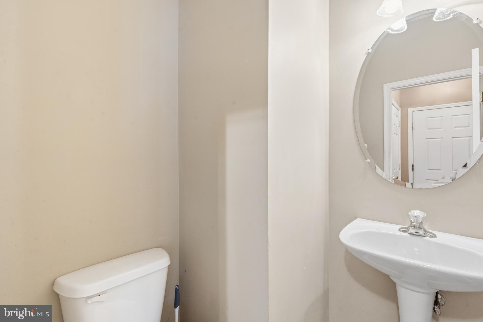 3132 Raking Leaf Drive Abingdon, MD 21009 - Photo 6 of 31 a bathroom with a toilet a sink and mirror