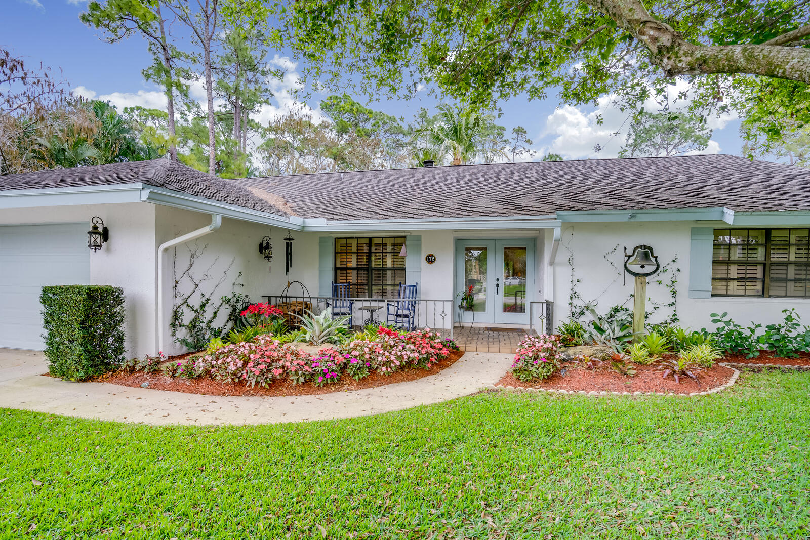 172 Wild Pine Road Wellington, FL 33414 - Photo 1 of 38 a front view of house with a garden and porch