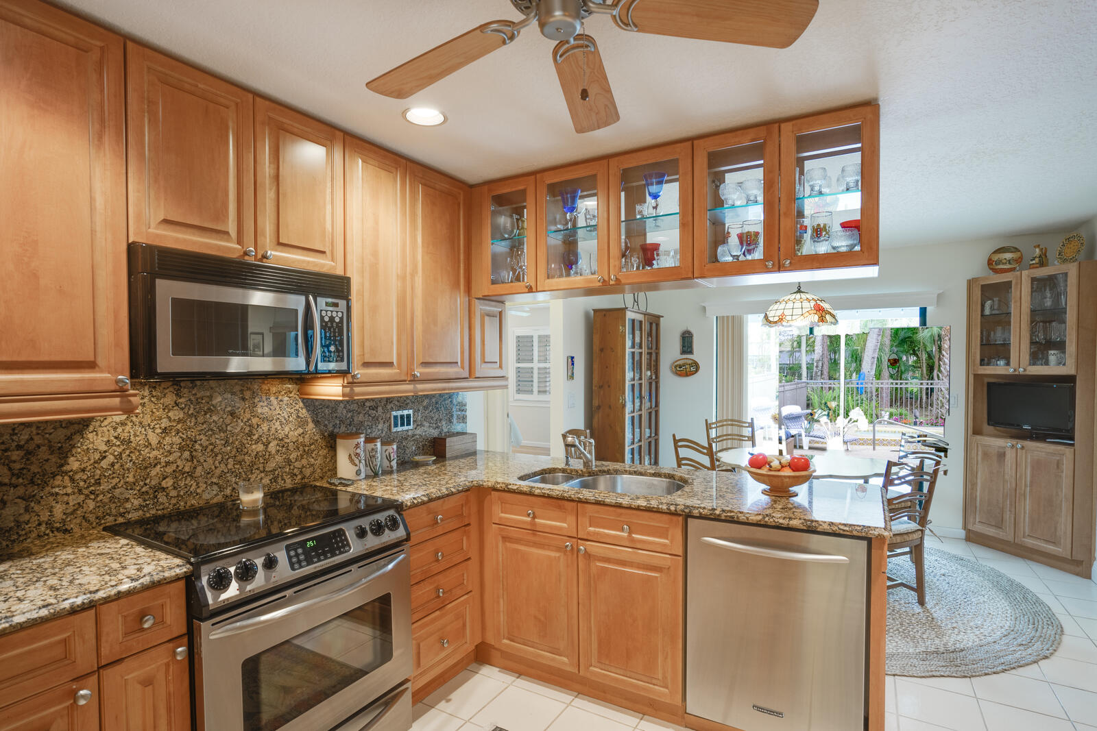 172 Wild Pine Road Wellington, FL 33414 - Photo 14 of 38 a kitchen with stainless steel appliances granite countertop a stove a sink and a microwave