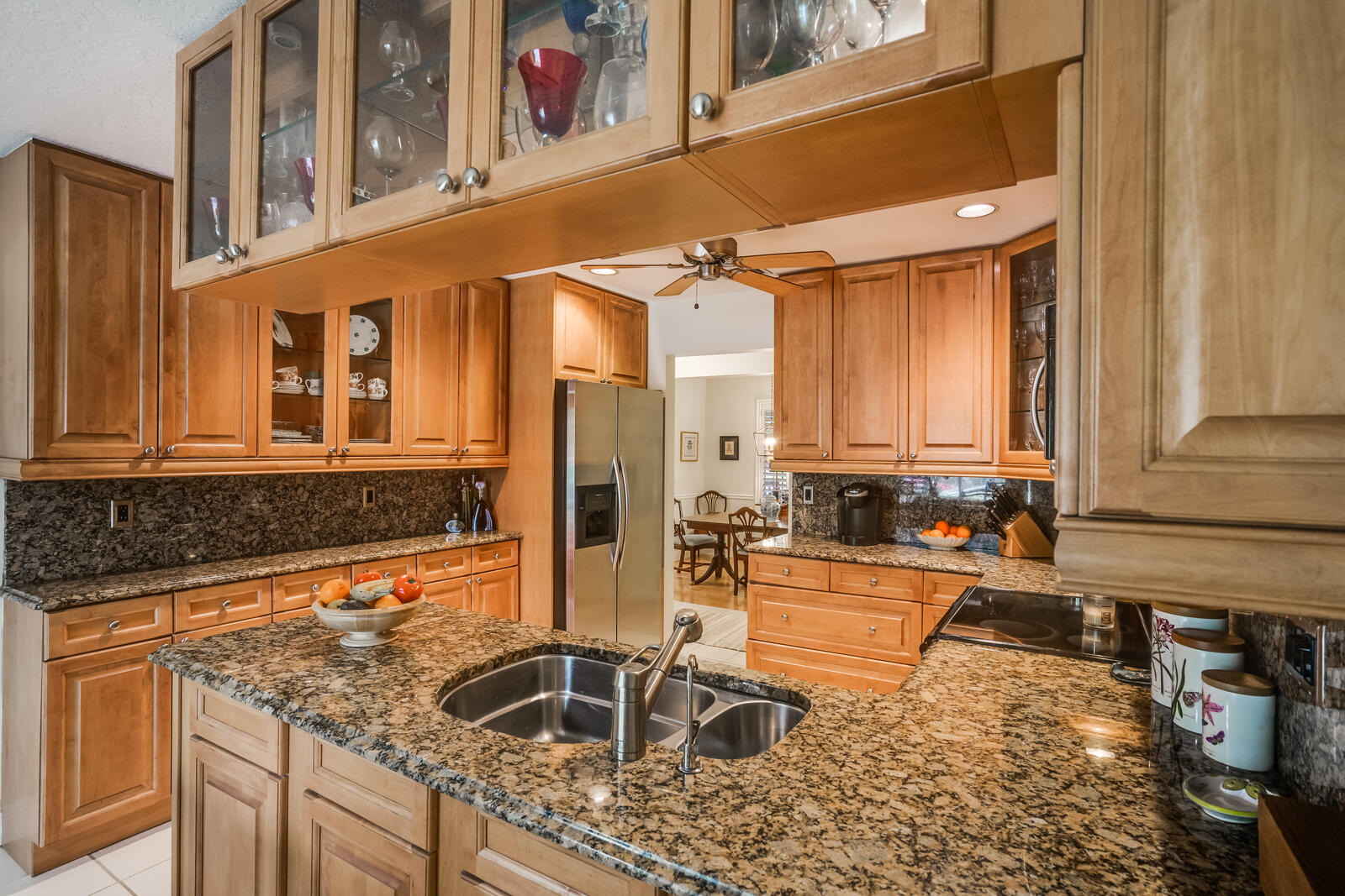 172 Wild Pine Road Wellington, FL 33414 - Photo 15 of 38 a kitchen with stainless steel appliances granite countertop a sink and a stove next to a window