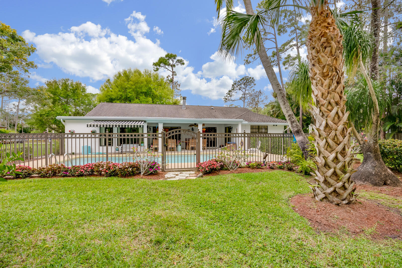 172 Wild Pine Road Wellington, FL 33414 - Photo 29 of 38 a view of a house with a yard and sitting area