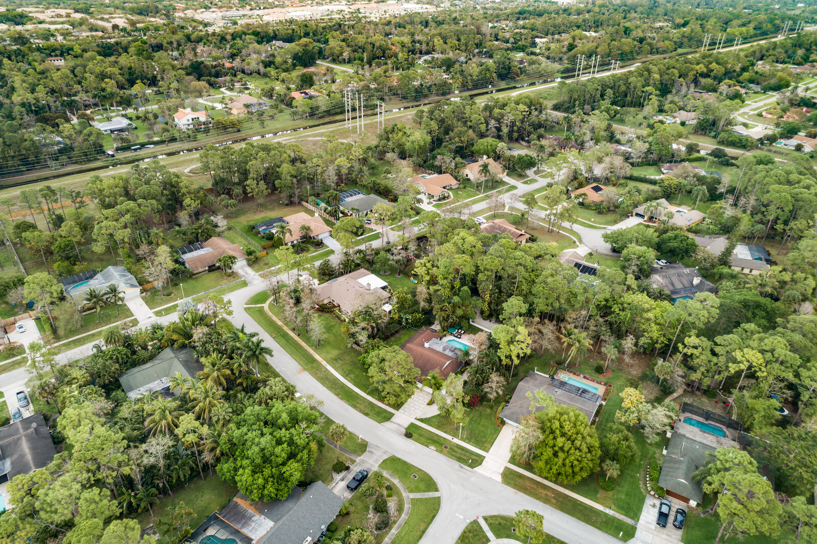 172 Wild Pine Road Wellington, FL 33414 - Photo 36 of 38 an aerial view of residential houses with outdoor space and trees