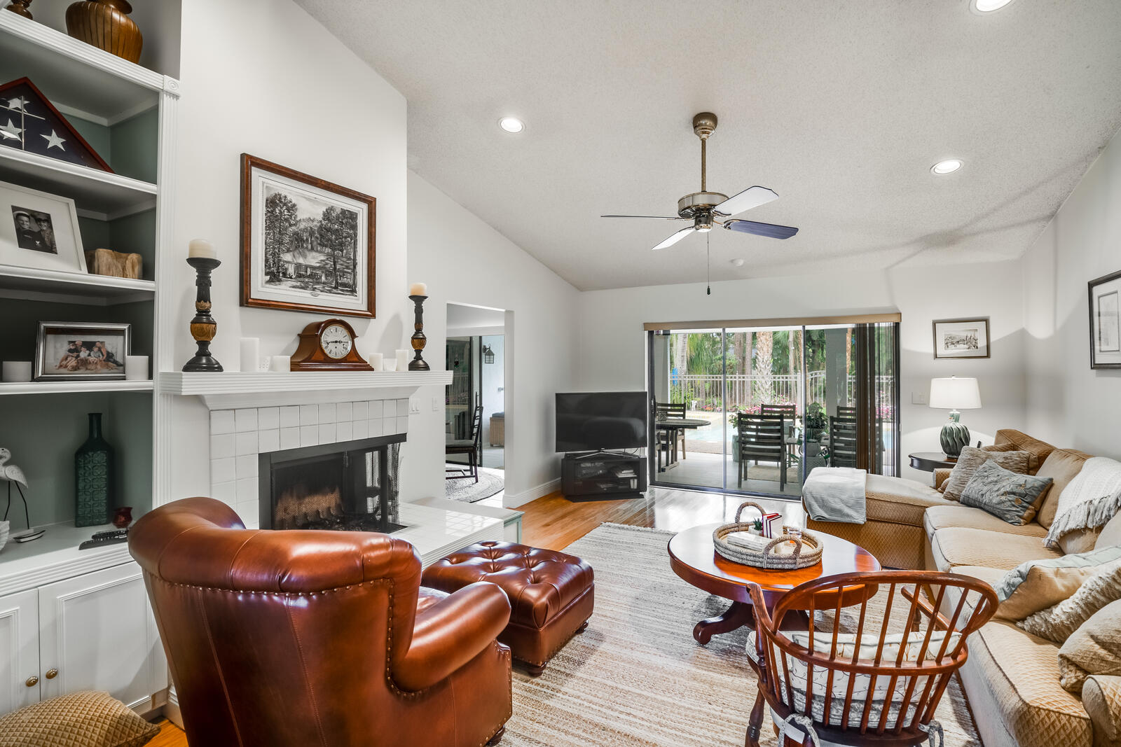 172 Wild Pine Road Wellington, FL 33414 - Photo 7 of 38 a living room with furniture a fireplace and a large window