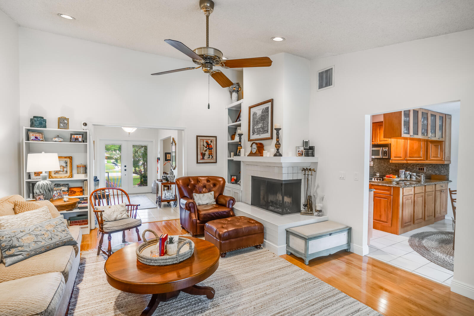 172 Wild Pine Road Wellington, FL 33414 - Photo 9 of 38 a living room with furniture a fireplace and a flat screen tv