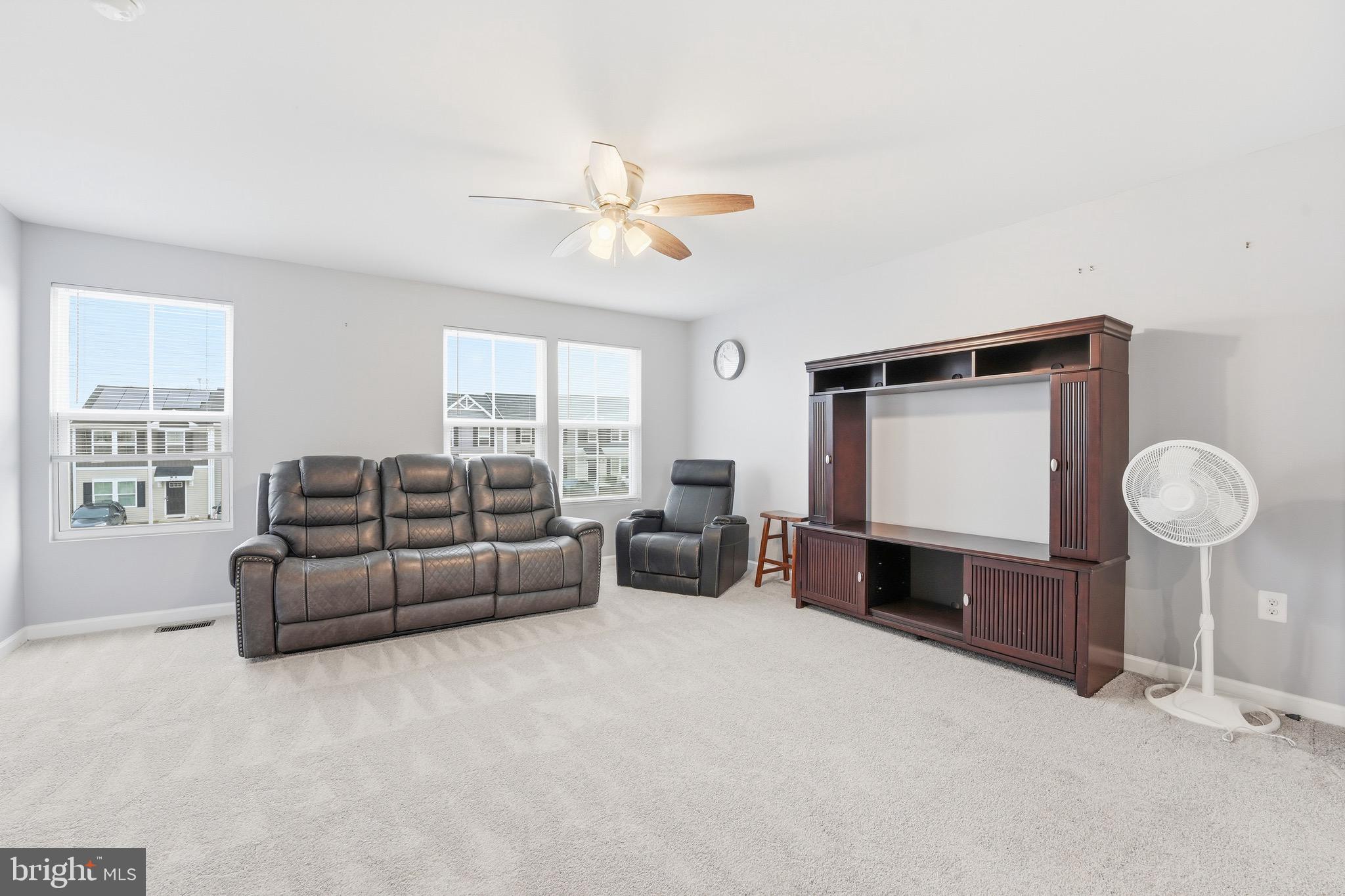 35209 Sara Court Locust Grove, VA 22508 - Photo 17 of 37 a living room with furniture a ceiling fan and a window