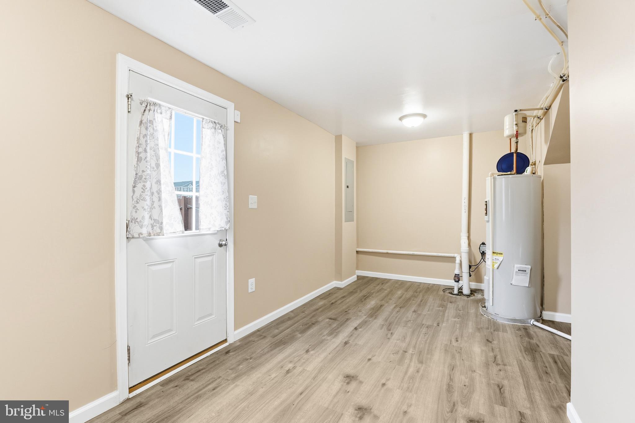 35209 Sara Court Locust Grove, VA 22508 - Photo 22 of 37 a view of an empty room with wooden floor and a window