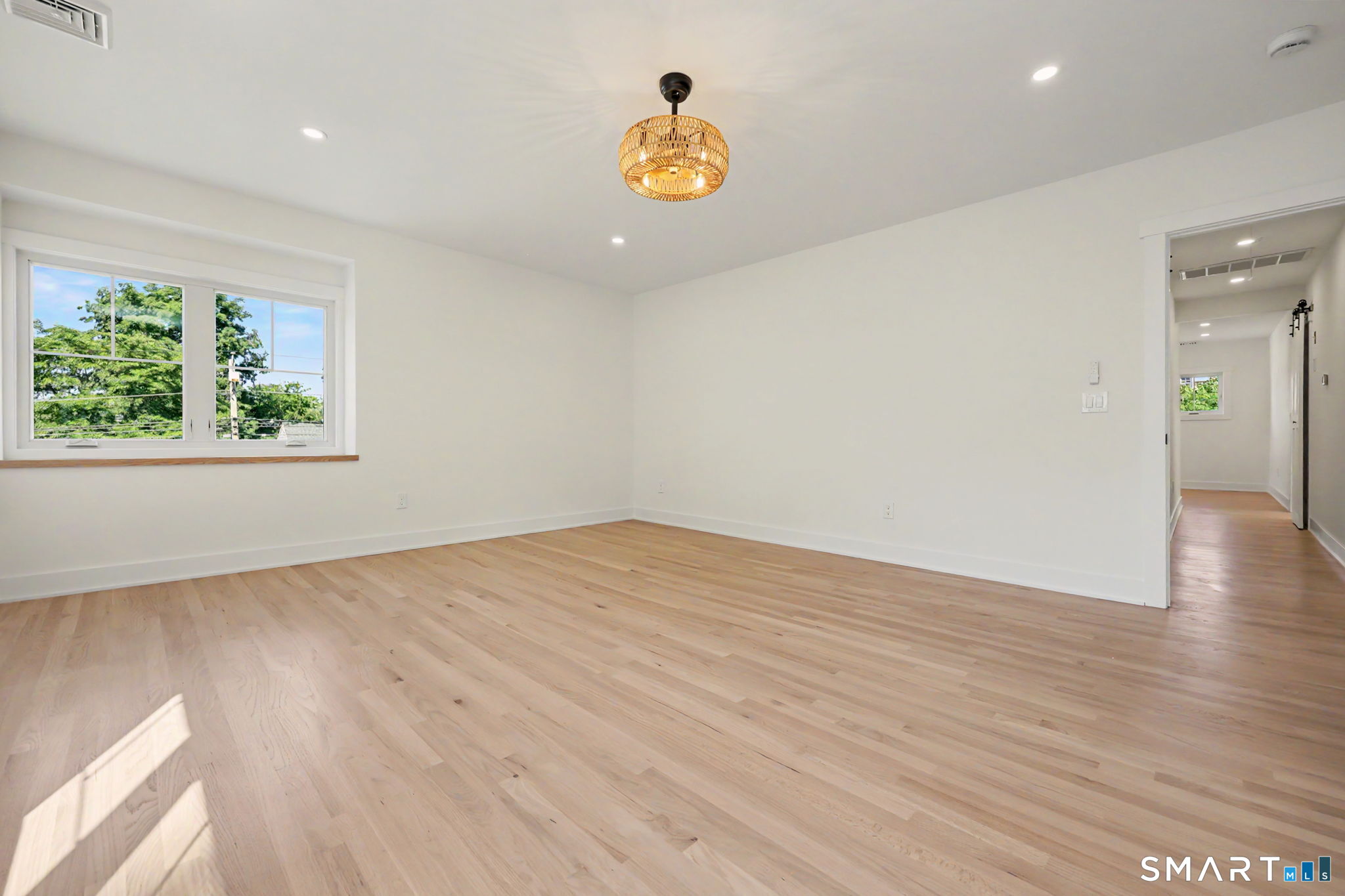 91 Lockwood Road Fairfield, CT 06825 - Photo 24 of 38 a view of empty room with wooden floor and window