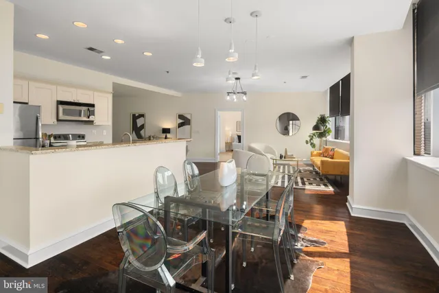 a view of a dining room with furniture and wooden floor