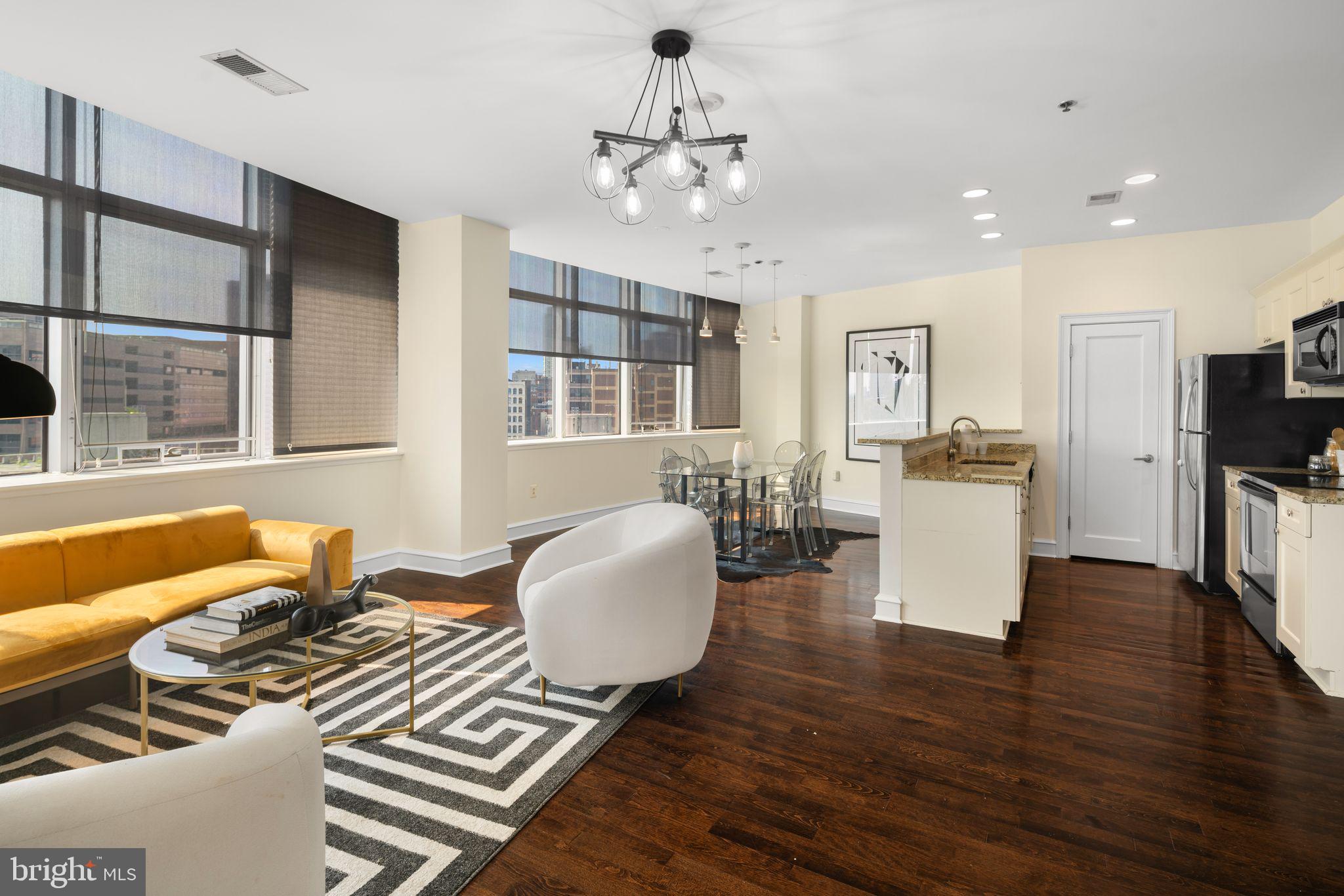 201-59 North 8th Street, Unit 603 Philadelphia, PA 19106 - Photo 14 of 35 a living room with furniture two window and wooden floor