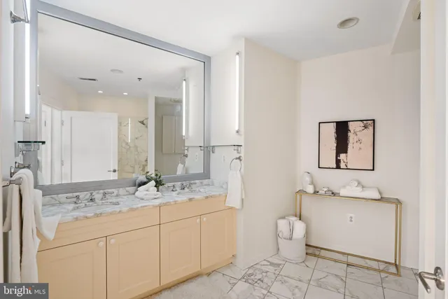 a bathroom with a double vanity sink and a mirror