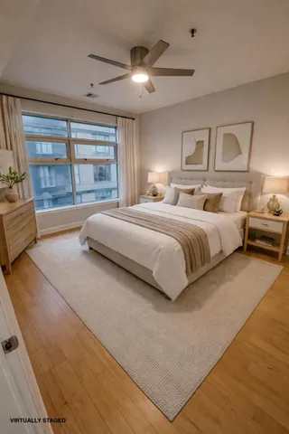 a spacious bedroom with a large bed and a large window