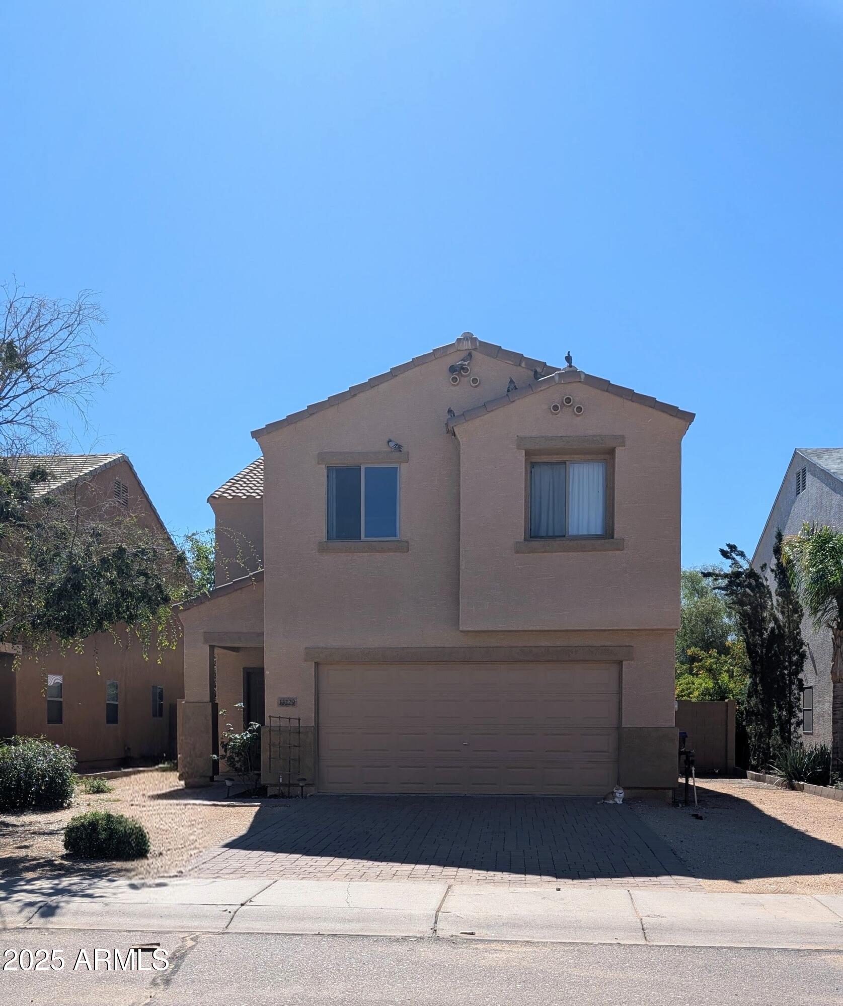a front view of a house with a garage