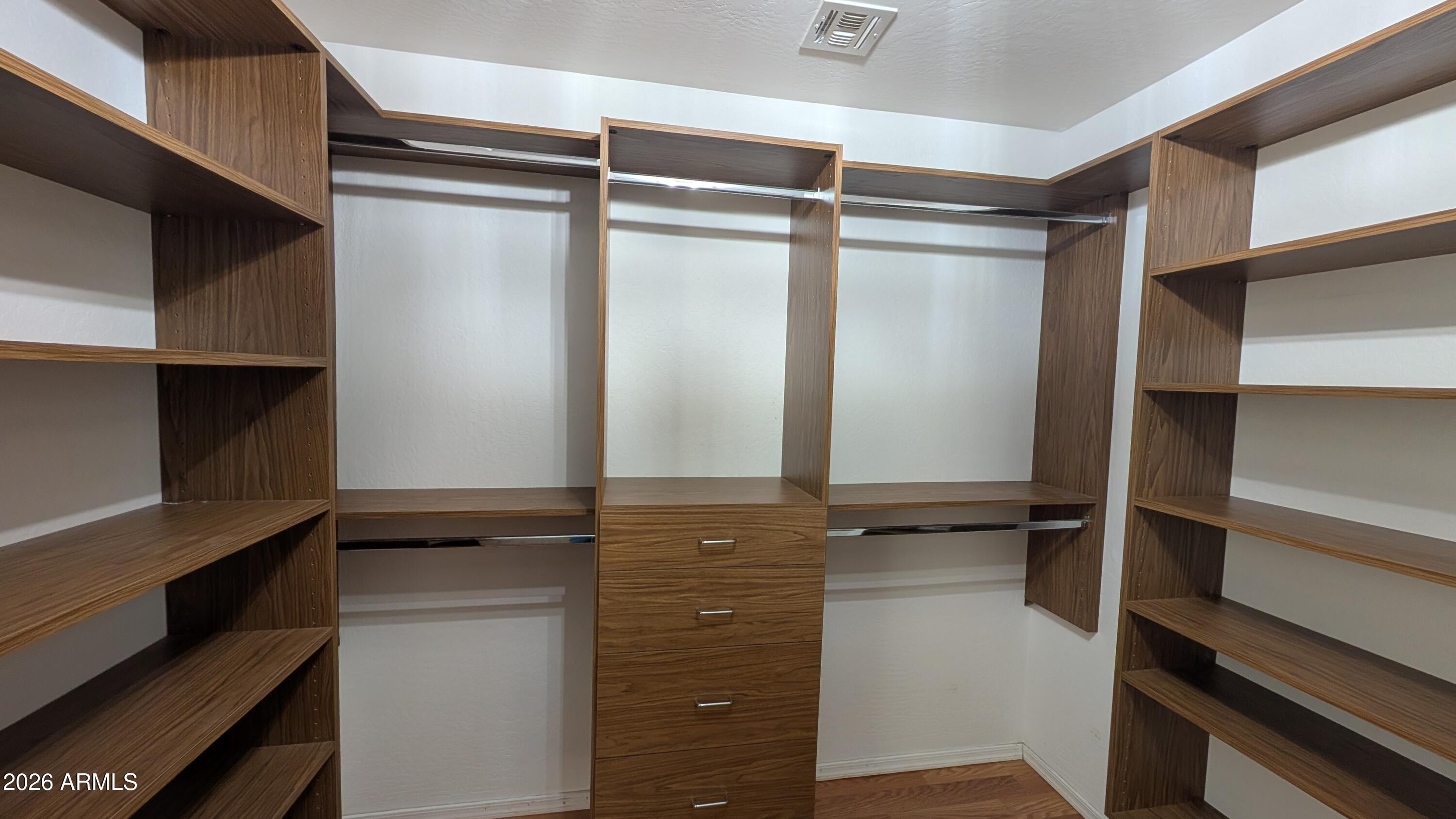 13229 East Primrose Lane Florence, AZ 85132 - Photo 4 of 11 a view of walk in closet with clothes and shoes