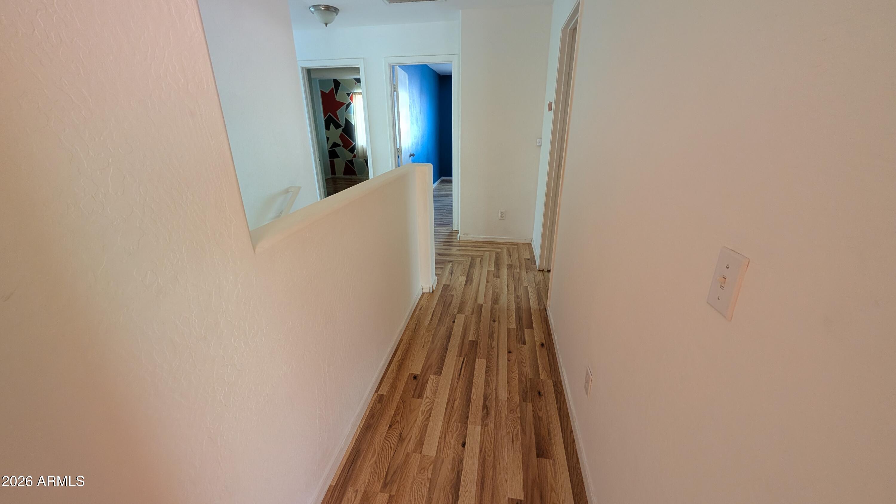 13229 East Primrose Lane Florence, AZ 85132 - Photo 10 of 11 a view of a hallway with wooden floor and staircase