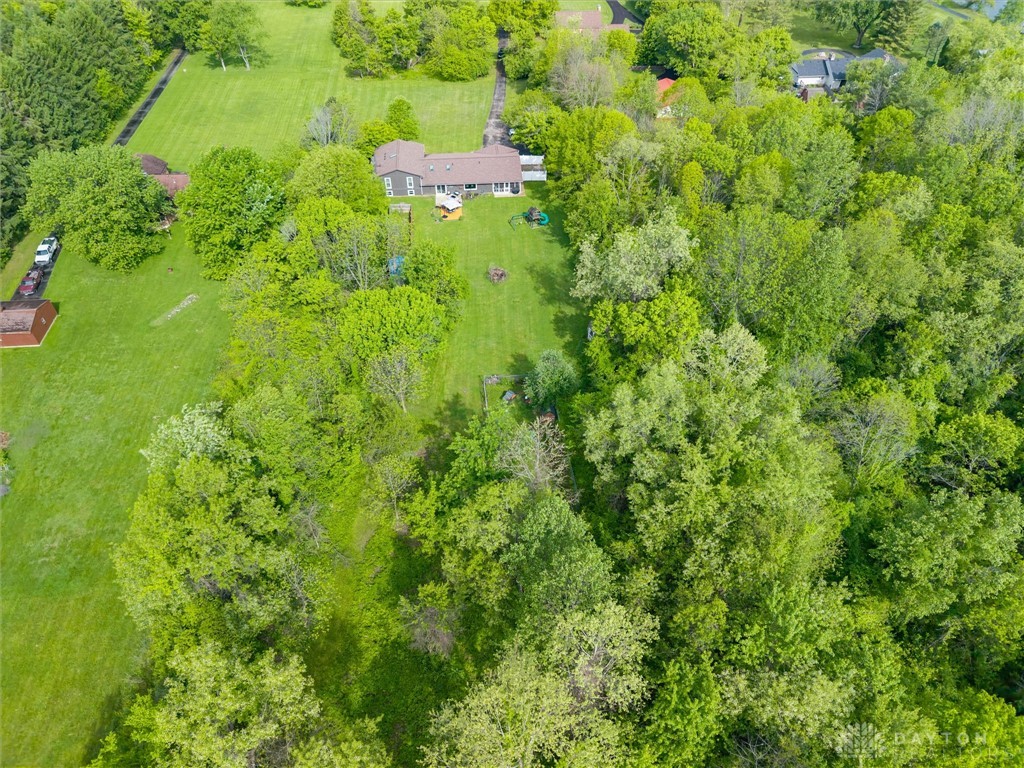 2165 Stewart Road Xenia, OH 45385 - Photo 43 of 59 This aerial view showcases a verdant property with mature trees and ample green space.