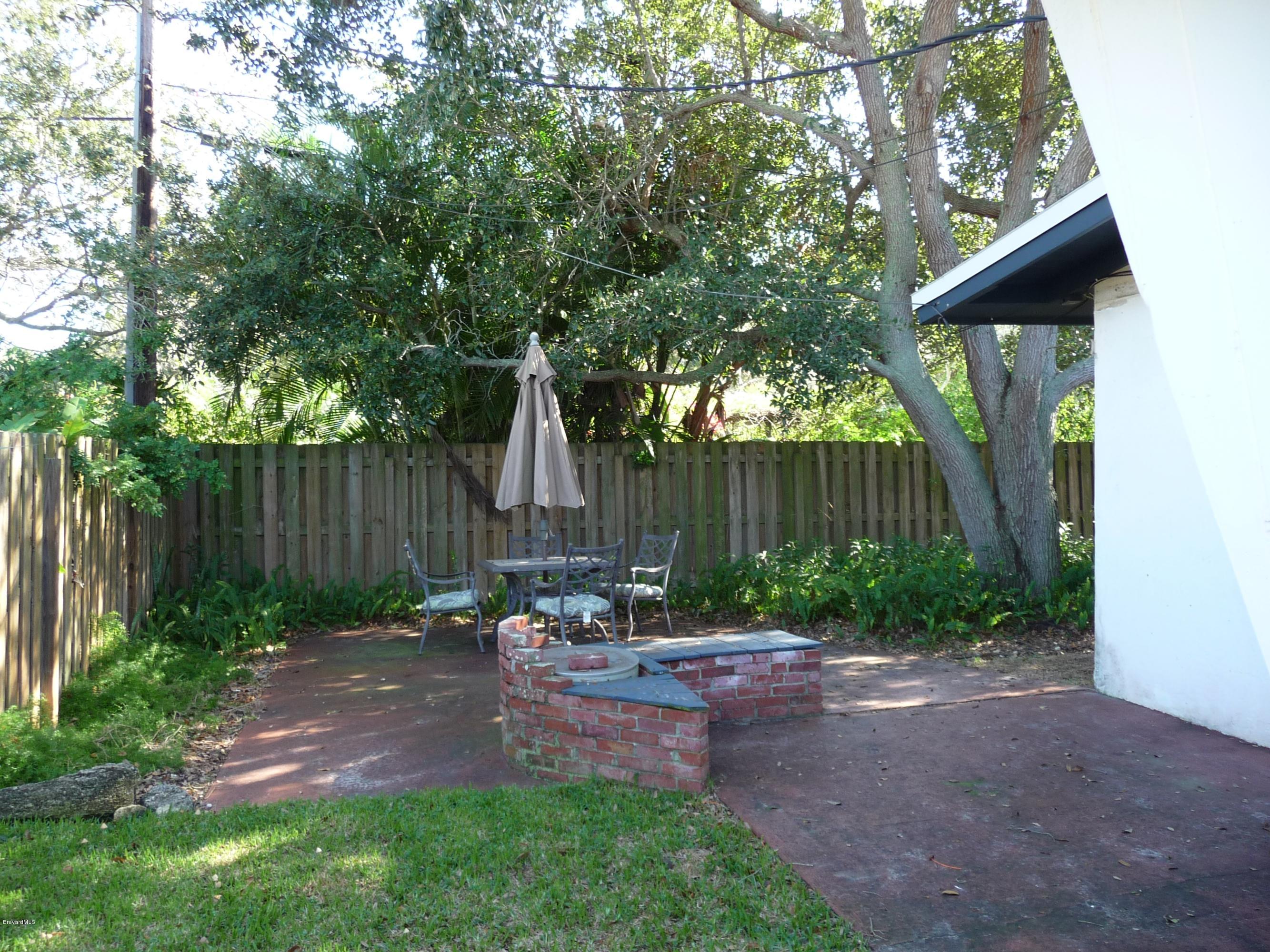 966 Santa Cruz Road Cocoa Beach, FL 32931 - Photo 3 of 12 Privacy fenced yard w/patio and firepit