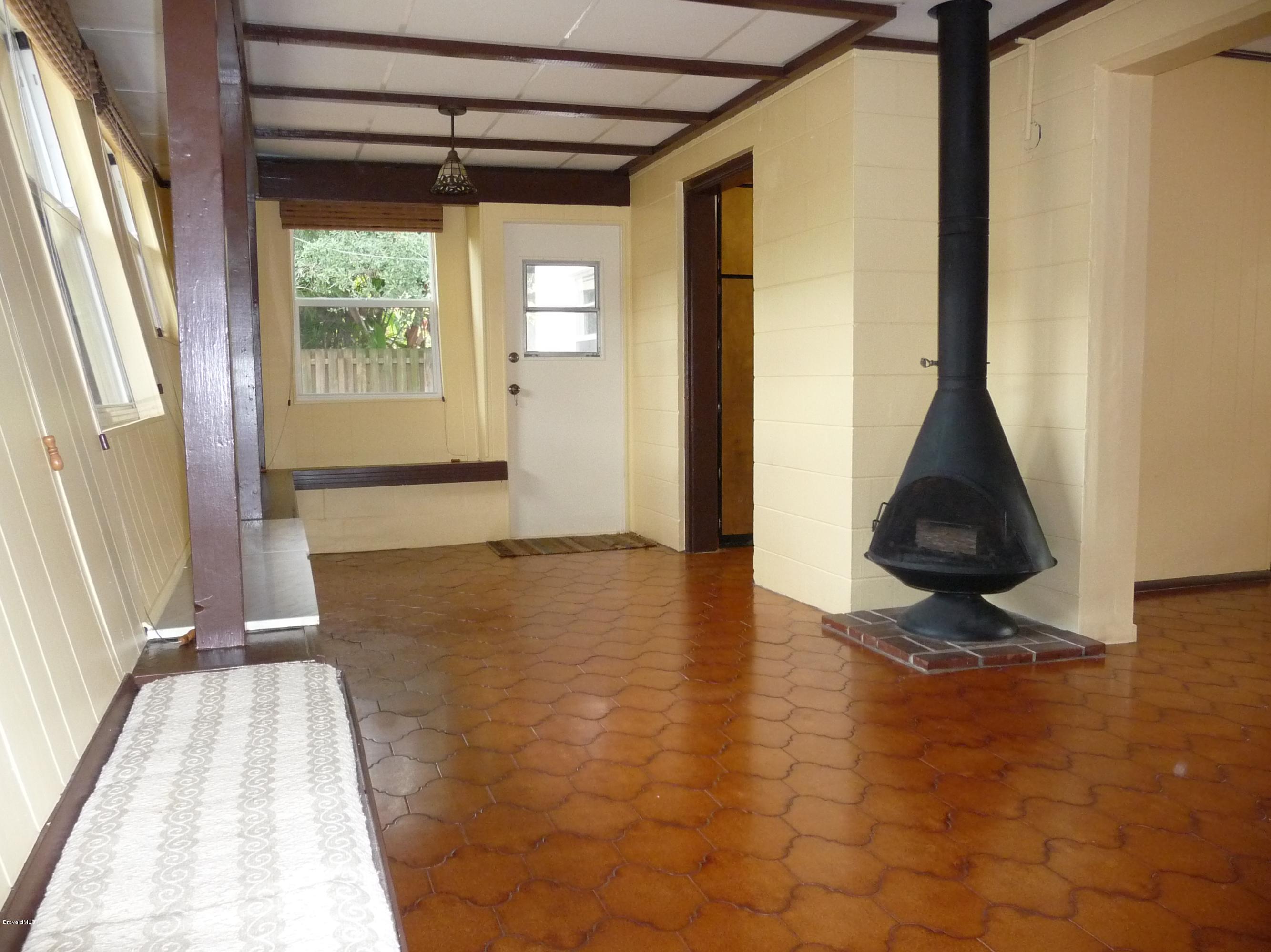 966 Santa Cruz Road Cocoa Beach, FL 32931 - Photo 6 of 12 Family area w/woodburning fireplace