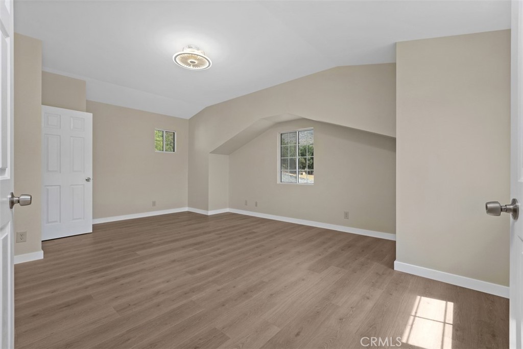 35768 Rice Canyon Road Fallbrook, CA 92028 - Photo 24 of 39 an empty room with wooden floor and windows