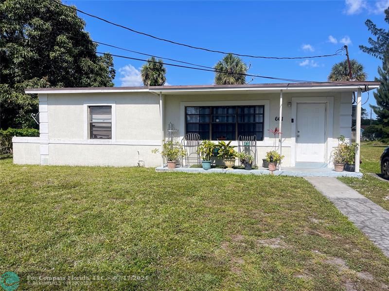 Broward Estates Lauderhill, FL 33311 - Photo 2 of 7 a front view of house with a garden and patio