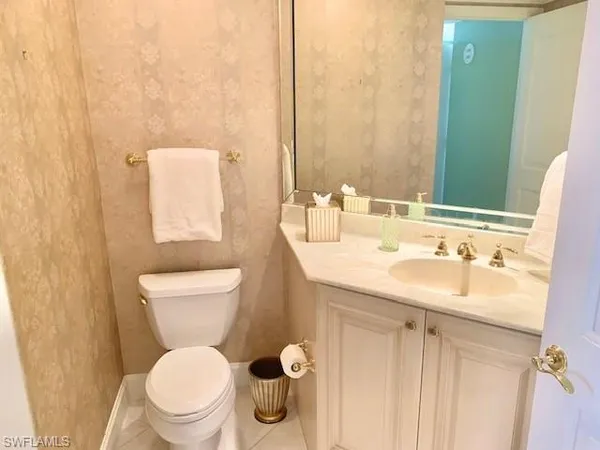 a bathroom with a toilet sink and mirror