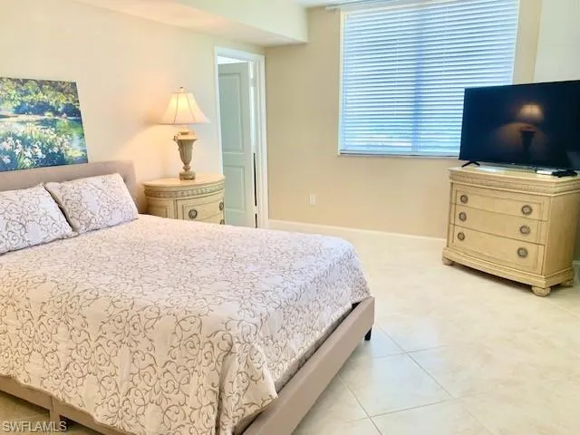 a bedroom with a bed and flat screen tv