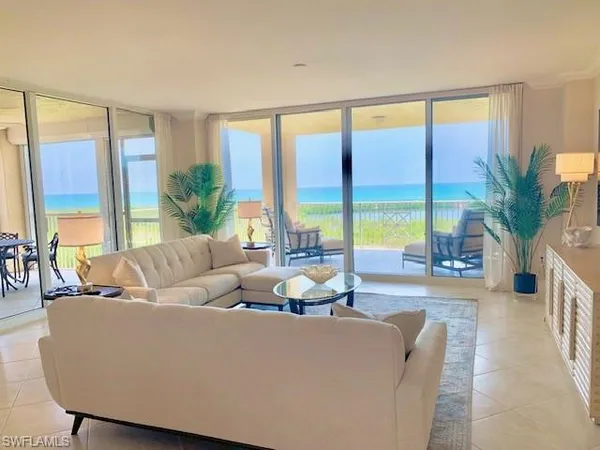 a living room with furniture and a large window with outer view