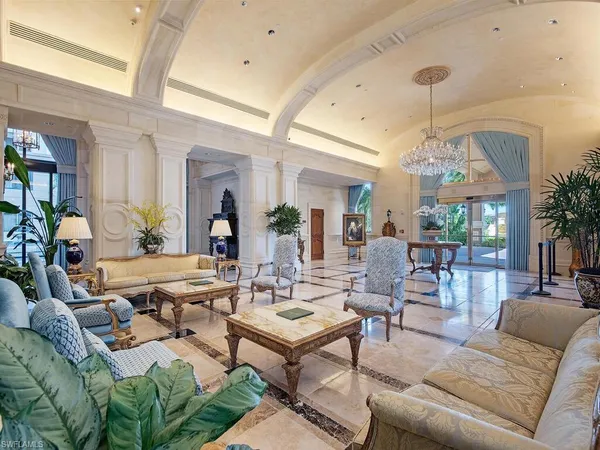 a living room with lots of furniture and a large mirror