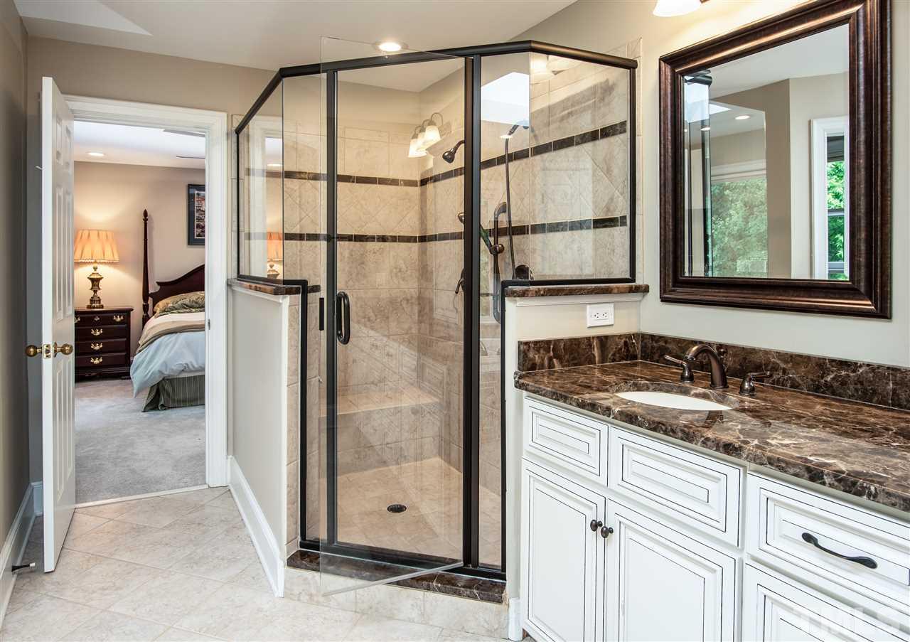 809 Ascot Lane Raleigh, NC 27615 - Photo 14 of 25 a bathroom with a granite countertop sink and a mirror