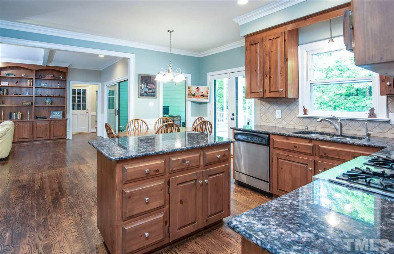 809 Ascot Lane Raleigh, NC 27615 - Photo 5 of 25 a kitchen with stainless steel appliances granite countertop a sink dishwasher stove and cabinets with wooden floor