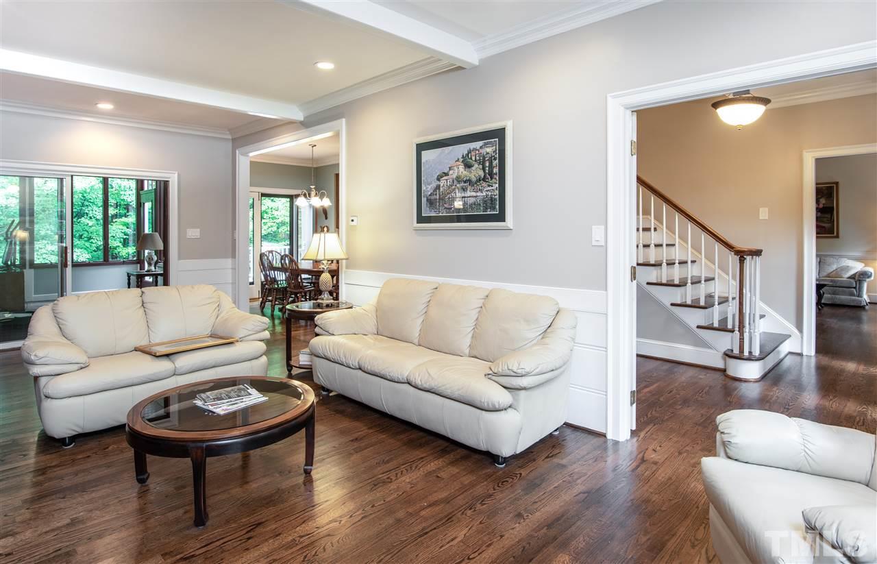 809 Ascot Lane Raleigh, NC 27615 - Photo 8 of 25 a living room with furniture a wooden floor and a large window