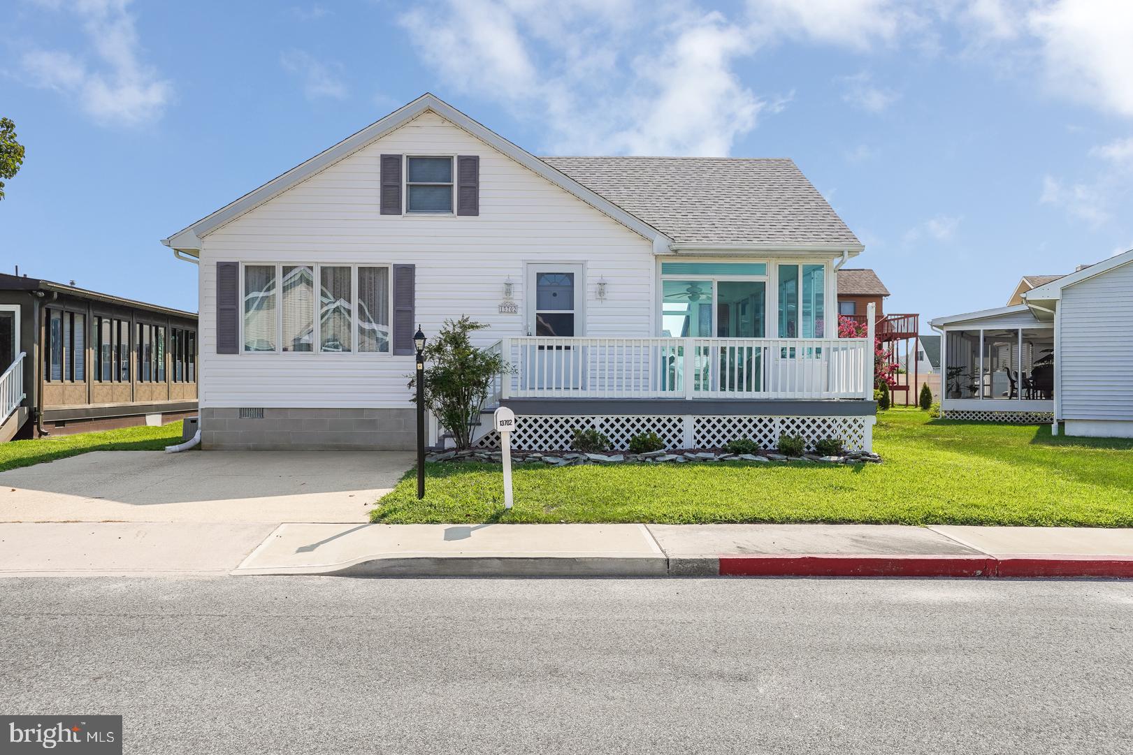 a front view of a house with a garden and plants