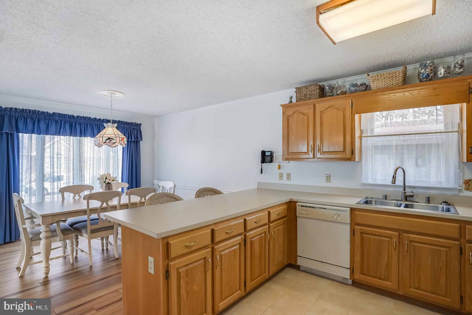 13702 Sailing Road Ocean City, MD 21842 - Photo 10 of 32 a kitchen with a sink stove and cabinets
