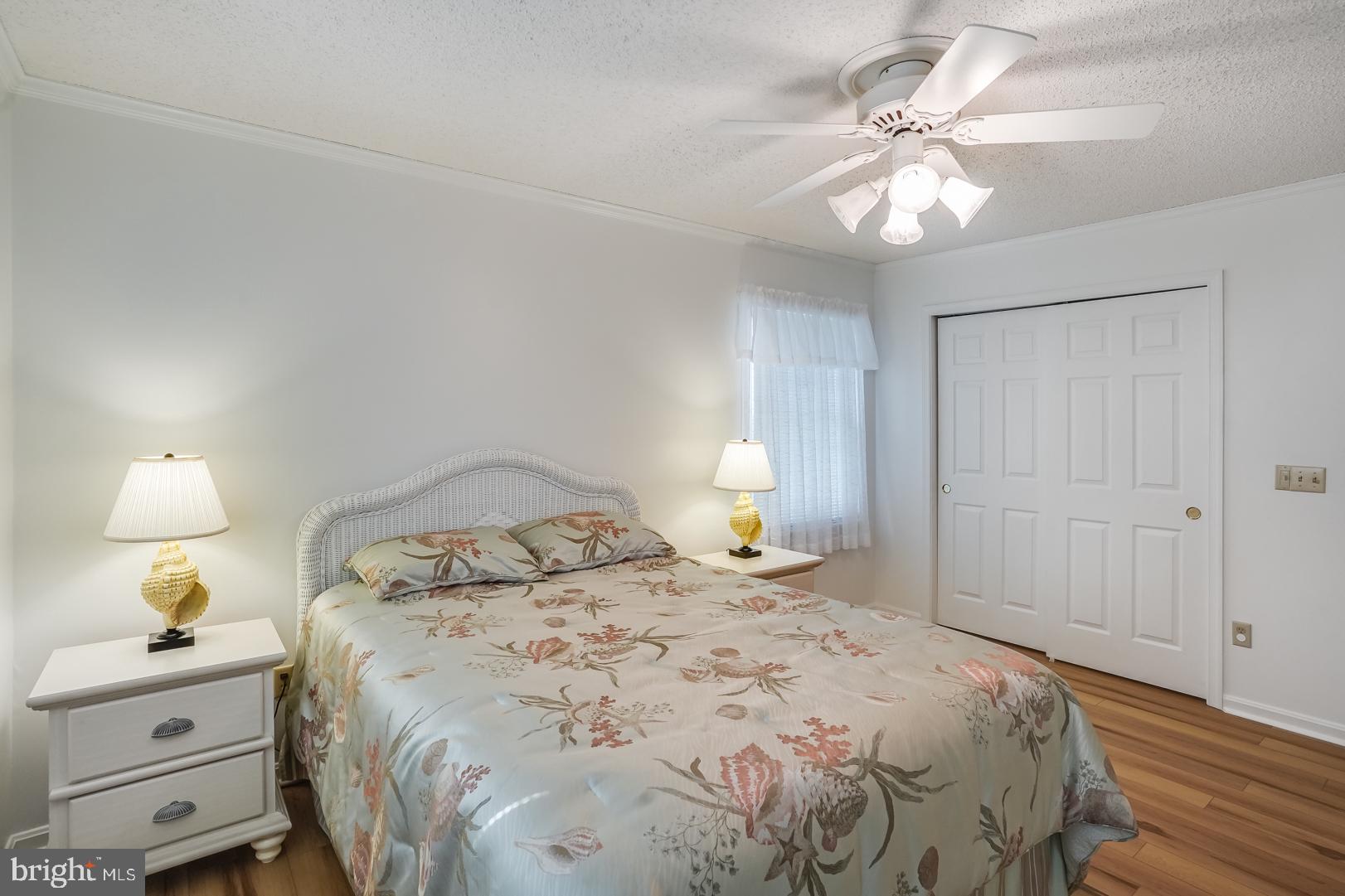 13702 Sailing Road Ocean City, MD 21842 - Photo 23 of 32 a bedroom with a bed and a chandelier