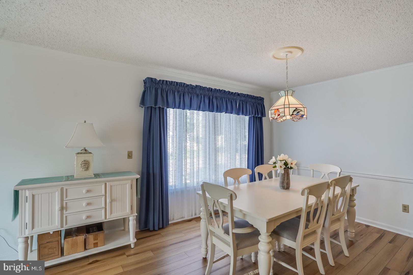 13702 Sailing Road Ocean City, MD 21842 - Photo 6 of 32 a view of a dining room with furniture window and wooden floor
